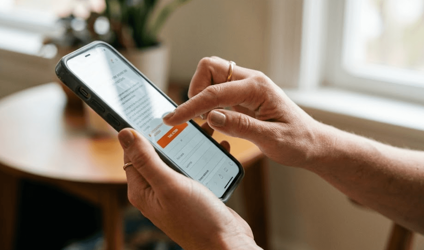 Hand tapping phone screen to sign an action
